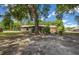 Spacious backyard with mature trees and partial chain link fencing at 164 Ne 53Rd St, Ocala, FL 34479