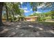 Spacious backyard featuring mature trees, partial fencing and direct access to the home at 164 Ne 53Rd St, Ocala, FL 34479