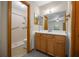 Bathroom featuring a vanity with a mirror, a walk-in shower, and tiled walls at 164 Ne 53Rd St, Ocala, FL 34479