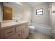 The bathroom features a bathtub, single sink vanity, and commode at 164 Ne 53Rd St, Ocala, FL 34479