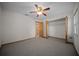 Bedroom featuring a ceiling fan, closet, and adjoining doorway at 164 Ne 53Rd St, Ocala, FL 34479