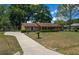 A well-kept single-story home on a spacious lot featuring a paved driveway, mature trees and a brick facade at 164 Ne 53Rd St, Ocala, FL 34479