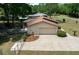Aerial view of a detached garage with concrete driveway and manicured landscaping at 164 Ne 53Rd St, Ocala, FL 34479