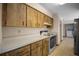 Kitchen with white countertops, wooden cabinets, and modern appliances at 164 Ne 53Rd St, Ocala, FL 34479