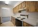 Traditional kitchen featuring wooden cabinets, white countertops, and a white electric range oven at 164 Ne 53Rd St, Ocala, FL 34479