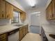 Well-lit kitchen featuring classic wooden cabinets, a view to dining room and appliances at 164 Ne 53Rd St, Ocala, FL 34479