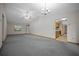 A spacious living room with updated ceiling fans, chandelier, window views, and an open entrance into the kitchen at 164 Ne 53Rd St, Ocala, FL 34479
