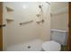 Walk-in shower with handrails, built-in shelves, and white tile walls in the bathroom at 164 Ne 53Rd St, Ocala, FL 34479
