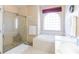 Bright bathroom with a large soaking tub, shower with glass door and tiled surround, and large window at 1763 Sw 155Th Place Rd, Ocala, FL 34473