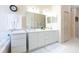 Bright bathroom with a double sink vanity, large soaking tub, and a tiled floor at 1763 Sw 155Th Place Rd, Ocala, FL 34473
