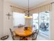 Cozy dining area with a round table, comfortable chairs, and an outdoor patio view at 1763 Sw 155Th Place Rd, Ocala, FL 34473