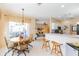 Open dining area with a round table, seating for six, and access to an outdoor patio at 1763 Sw 155Th Place Rd, Ocala, FL 34473