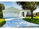 Well-kept single-story home with a three-car garage, decorative driveway, and manicured front yard at 1763 Sw 155Th Place Rd, Ocala, FL 34473