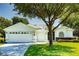 Charming one-story home featuring a three-car garage, well-maintained lawn, and mature landscaping at 1763 Sw 155Th Place Rd, Ocala, FL 34473