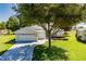 Charming single-story home with a well-manicured lawn, attached garages, and beautiful landscaping at 1763 Sw 155Th Place Rd, Ocala, FL 34473