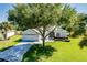 Charming home with well-manicured lawn, mature trees, and a welcoming entrance, creating great curb appeal at 1763 Sw 155Th Place Rd, Ocala, FL 34473