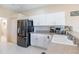 Bright kitchen featuring white cabinets, stainless steel appliances, and a patterned backsplash at 1763 Sw 155Th Place Rd, Ocala, FL 34473