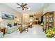 Spacious living room boasting tile floors, a ceiling fan, and access to the home's entryway and office at 1763 Sw 155Th Place Rd, Ocala, FL 34473