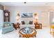 Inviting living room with tile flooring, a boat painting, and a traditional grandfather clock at 1763 Sw 155Th Place Rd, Ocala, FL 34473
