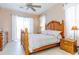 Traditional bedroom featuring a wooden bed frame, matching nightstands, and soft natural light at 1763 Sw 155Th Place Rd, Ocala, FL 34473