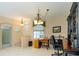 Functional office area with a wooden desk, tile floors, and access to the home's entryway at 1763 Sw 155Th Place Rd, Ocala, FL 34473