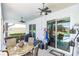 Covered patio with ceiling fans, dining table and chairs, and access to outdoor spaces at 1763 Sw 155Th Place Rd, Ocala, FL 34473