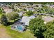 Backyard aerial view featuring a sparkling pool with screened-in lanai and green landscaping in a residential neighborhood at 1763 Sw 155Th Place Rd, Ocala, FL 34473
