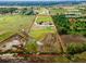 Expansive aerial view of a large lot, highlighting the property's boundaries, nearby wooded areas, and future neighborhood development at 22111 Obrien Rd, Howey In The Hills, FL 34737