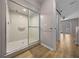 Bathroom showcasing an updated shower with sliding glass doors and wood-look floors at 2343 Se 19Th Cir, Ocala, FL 34471