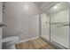 Bathroom featuring a shower with sliding glass doors and modern wood-look flooring at 2343 Se 19Th Cir, Ocala, FL 34471
