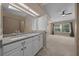 Bathroom features a vanity, mirror and natural light from a window at 2343 Se 19Th Cir, Ocala, FL 34471