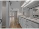 Bright bathroom with granite countertop vanity and sliding barn doors at 2343 Se 19Th Cir, Ocala, FL 34471