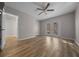 Bright bedroom with vinyl floors and ceiling fan and view to attached bathroom at 2343 Se 19Th Cir, Ocala, FL 34471