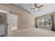 Bright bedroom features a ceiling fan, a large window offering natural light, and neutral color walls at 2343 Se 19Th Cir, Ocala, FL 34471