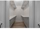 Walk-in closet featuring built-in shelving and modern floors at 2343 Se 19Th Cir, Ocala, FL 34471