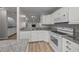 Bright kitchen with white cabinets, granite countertops, and modern appliances at 2343 Se 19Th Cir, Ocala, FL 34471