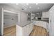 White kitchen with granite countertop island and open floor plan at 2343 Se 19Th Cir, Ocala, FL 34471
