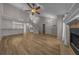 Open living room with hardwood floors, fireplace, staircase, and a view into the kitchen at 2343 Se 19Th Cir, Ocala, FL 34471