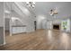 Open living room featuring hardwood floors, a fireplace, staircase, and wet bar at 2343 Se 19Th Cir, Ocala, FL 34471