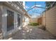 Private covered patio with pavers, synthetic grass, and stylish string lights for outdoor relaxation at 2343 Se 19Th Cir, Ocala, FL 34471