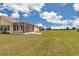 Expansive lawn and screened-in patio offer views of the lush, well-maintained grounds at 2369 Nw 53Rd Avenue Road, Ocala, FL 34482