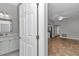 Bright bathroom features a white vanity with marble countertop and leads to the living area with ceiling fan at 2369 Nw 53Rd Avenue Road, Ocala, FL 34482