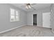 This bedroom features gray walls, carpet, white trim, plantation shutters, and a closet at 2369 Nw 53Rd Avenue Road, Ocala, FL 34482