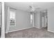 Empty bedroom with neutral walls, carpet, updated fan and two windows ready for new owners at 2369 Nw 53Rd Avenue Road, Ocala, FL 34482