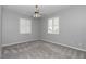 This bedroom features gray walls, carpet, white trim, plantation shutters, and a modern ceiling fan at 2369 Nw 53Rd Avenue Road, Ocala, FL 34482