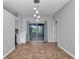 Bright, empty dining room featuring sliding glass doors and modern light fixtures ready for a new owner at 2369 Nw 53Rd Avenue Road, Ocala, FL 34482