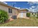 Exterior showcasing landscaped grounds, HVAC unit and an exterior door at 2369 Nw 53Rd Avenue Road, Ocala, FL 34482