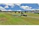 Aerial view of a beautiful golf course, highlighting the lush green fairways and blue skies at 2369 Nw 53Rd Avenue Road, Ocala, FL 34482