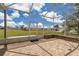 Screened lanai with brick flooring overlooks the lush backyard and neighborhood at 2369 Nw 53Rd Avenue Road, Ocala, FL 34482