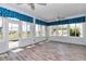 Sunroom features beautiful wood-look tile floors, bright windows, and ceiling fan at 2369 Nw 53Rd Avenue Road, Ocala, FL 34482